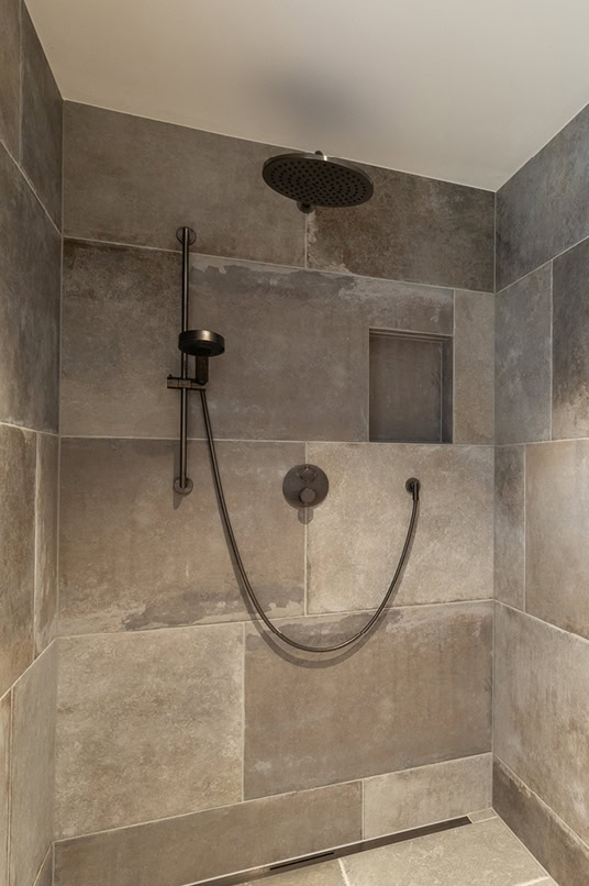 Ebenerdige Dusche mit grauen Steinfliesen